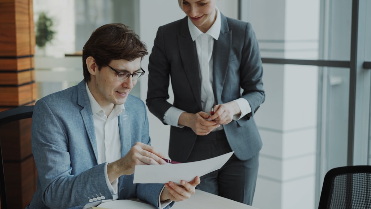 Two tax professionals reviewing IRS notices together at a desk
